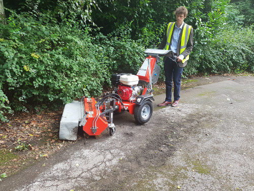 Removing moss and debris from tarmac drive