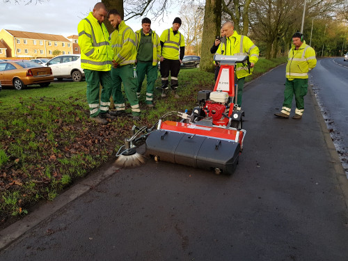 Sweeper with gulley brush maintaining the edge of a foot path