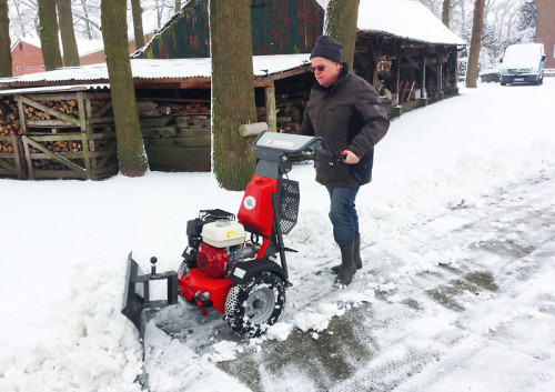 K1500 two wheel tractor ploughing snow on drive way