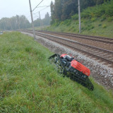 Kersten-Hycut-hybrid-mower-cutting-grass-on-a-steep-bank-besides-rail-track